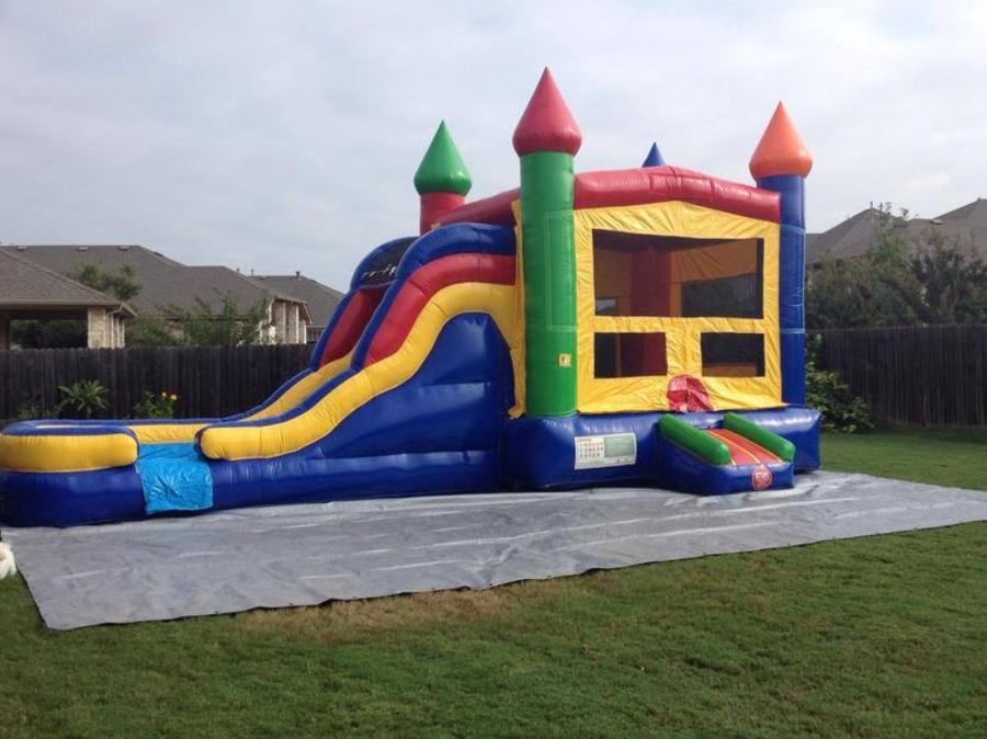 Combo bounce house rental Austin TX - castle combo with towers and slide by Jump Around Party Rentals