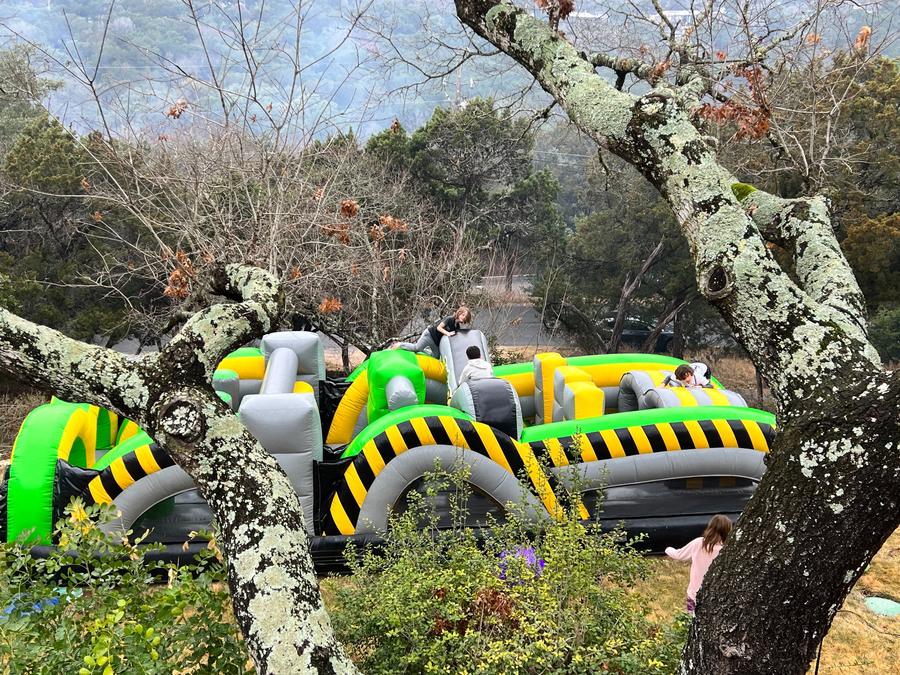 Jump Around Party Rentals inflatable obstacle course set up at Austin TX event - kids playing