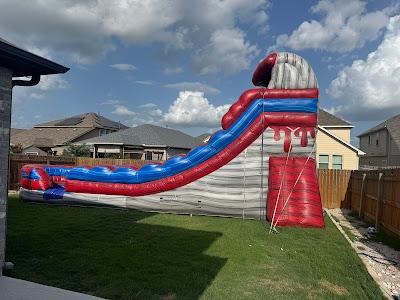 Large colorful inflatable water slide rental Austin TX - Jump Around Party Rentals backyard event